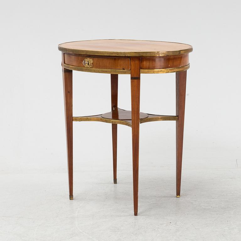 A mahogany veneered Louis XVI style table, 19th Century.