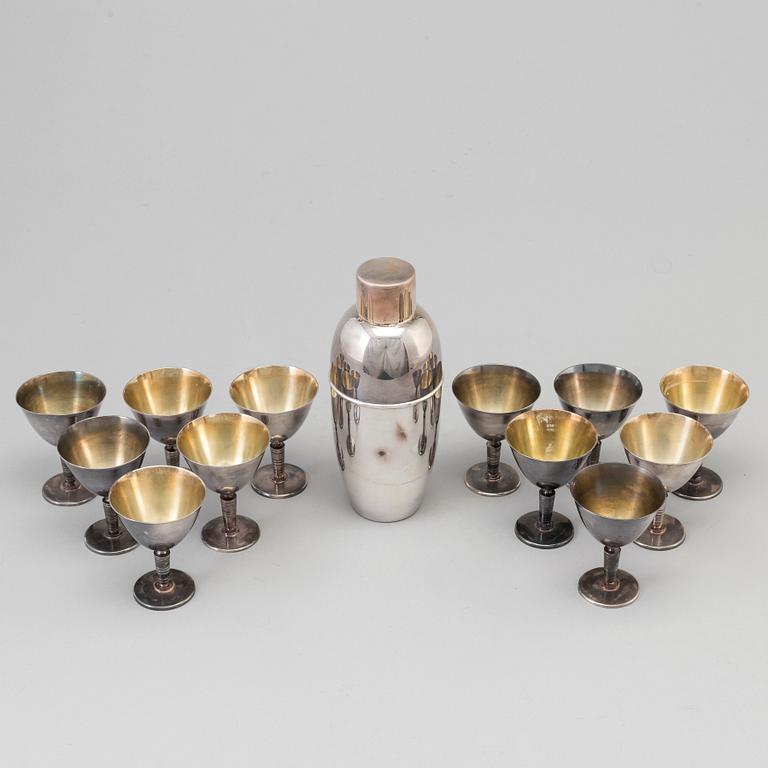 A silverplated shaker and 12 cocktail glasses from GAB and and a Shaker from CG Hallberg, Stockholm mid 20th century.
