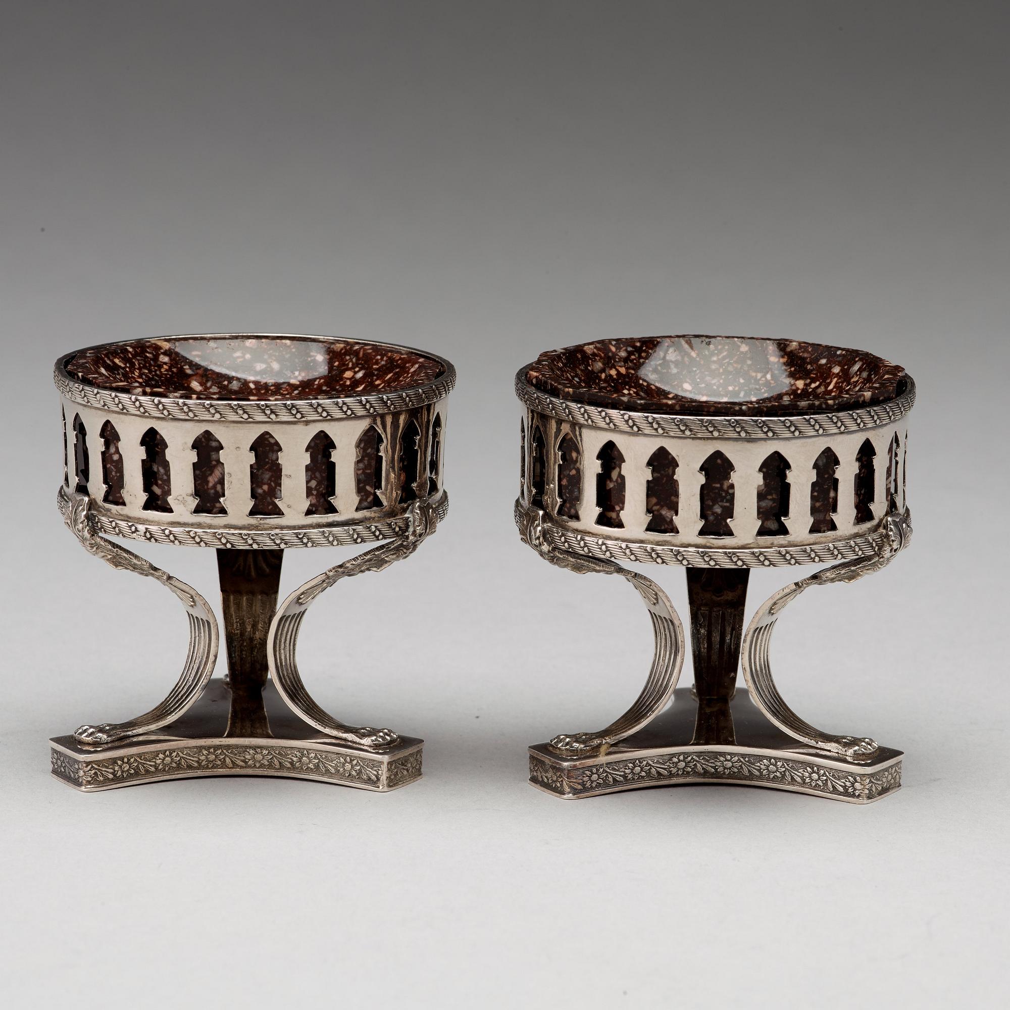 A pair of Swedish 19th century porphyry and silver salt-cellars, silver with mark of Gustaf Folcker, Stockholm 1823.