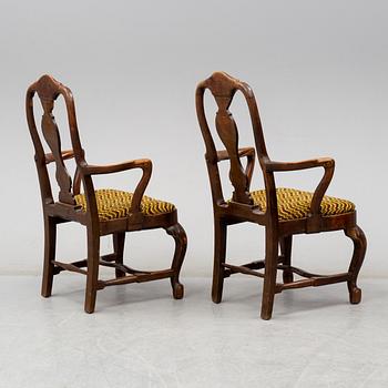 A pair of oak baroque style armrest chairs, 1920s.