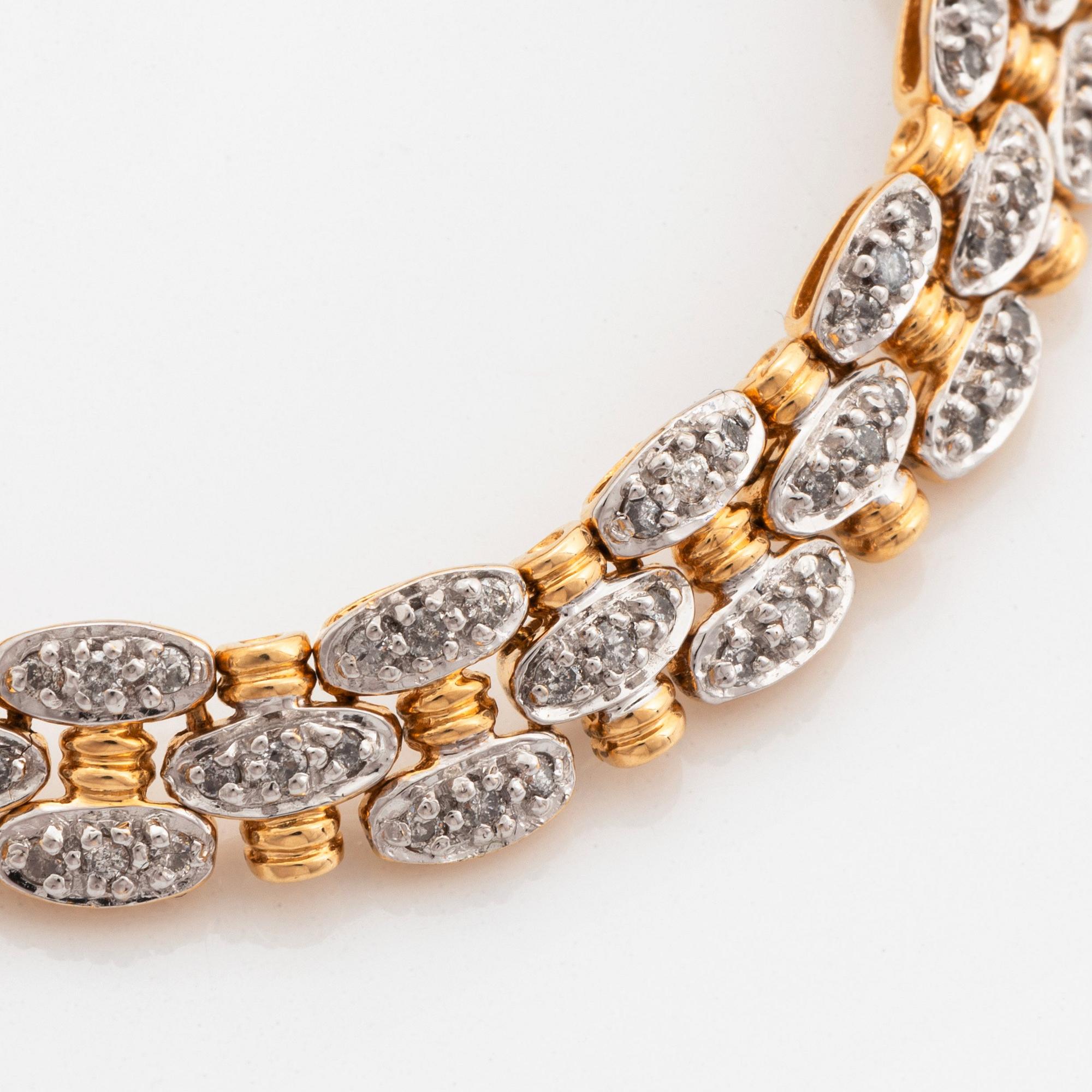 An 18K gold and white gold bracelet set with round brilliant-cut diamonds.