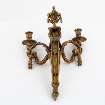 A pair of Louis XVI-style bronze wall sconces, late 19th century.