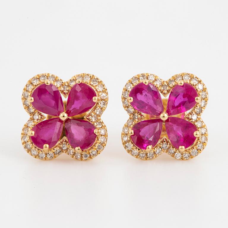 Pear shaped rubies and eight cut diamond flower earrings.