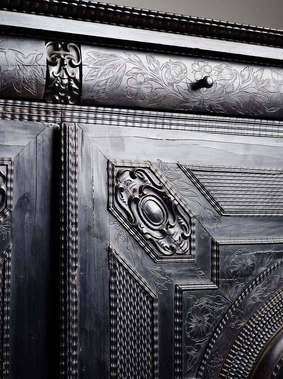 A Louis XIV and Louis XIV-style carved ebony, ivory and tortoiseshell-inlaid cabinet on stand, 17th and 19th century.