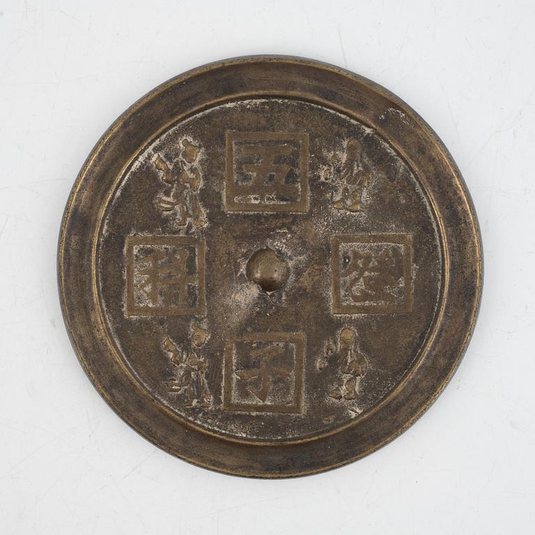 A bronze mirror, China, late Qing dynasty.