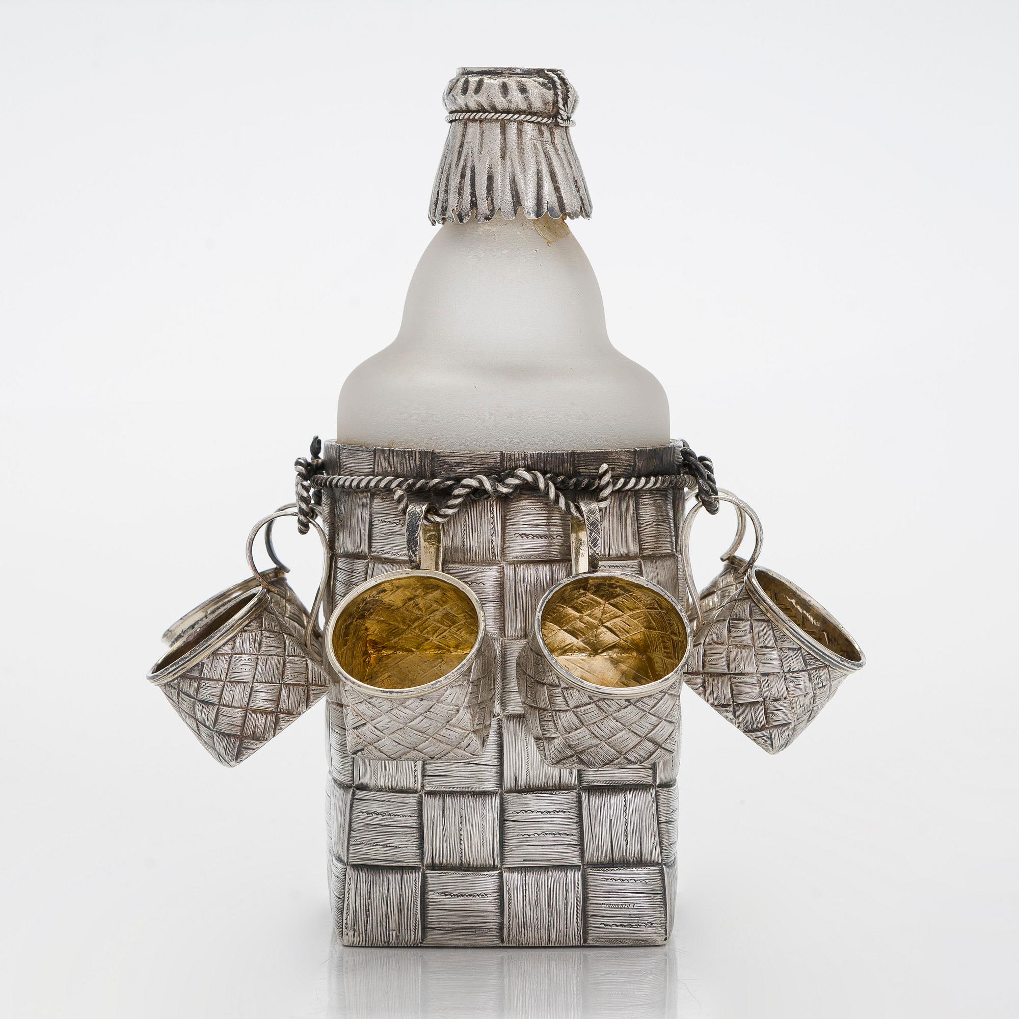 A silver and glass bottle with eight silver charka, maker marks of Pyotr Yermolajevich Davidov, Saint Petersburg, 1884.