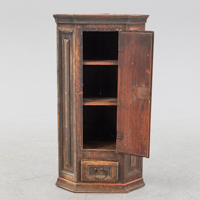 A painted corner cabinet, dated 1800.