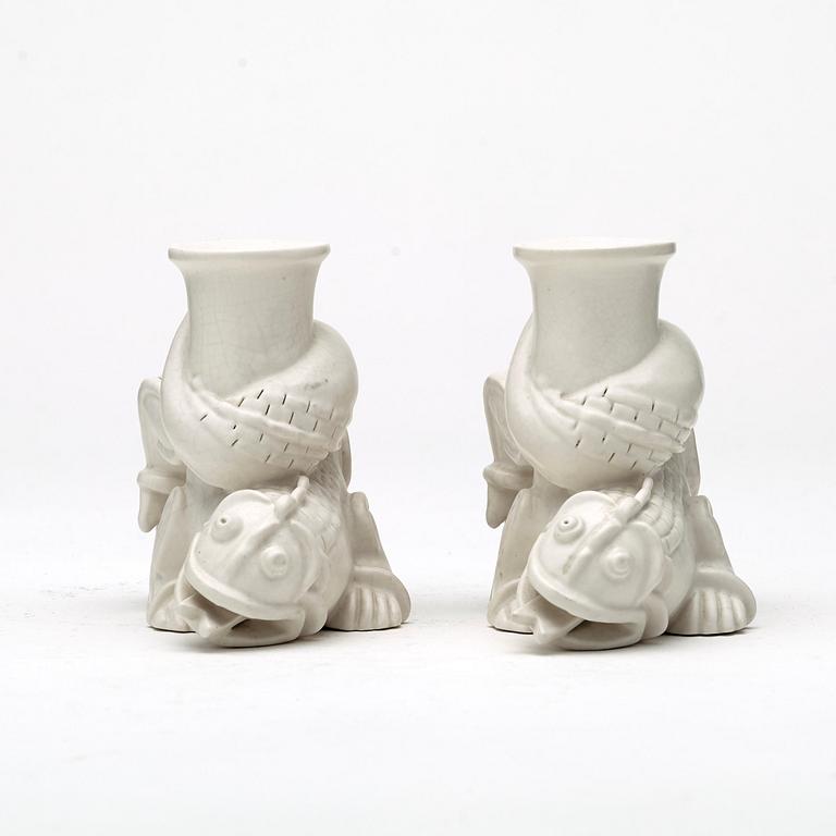 Wilhelm Kåge, a set of stoneware figures of a 'dragon puppy' and two 'dragon puppies' with candle holders, Gustavsberg, ca 1940.