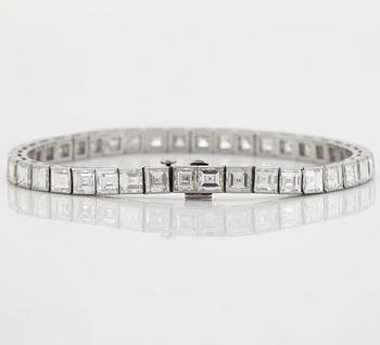 A platinum bracelet set with carré cut diamonds.