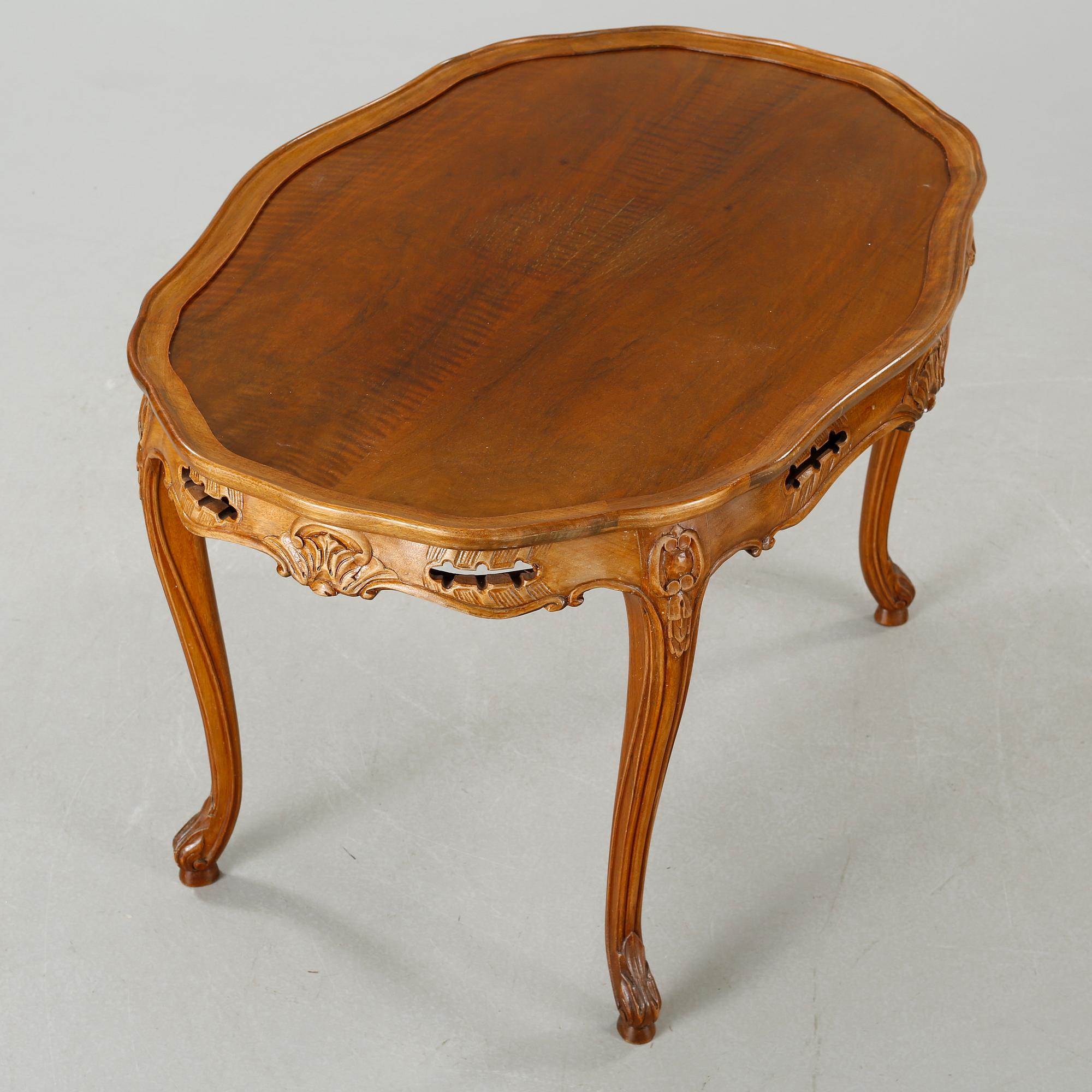 A rococo style sofa, two lounge chairs and a table, around the year 1900 and first half of the 20th century.