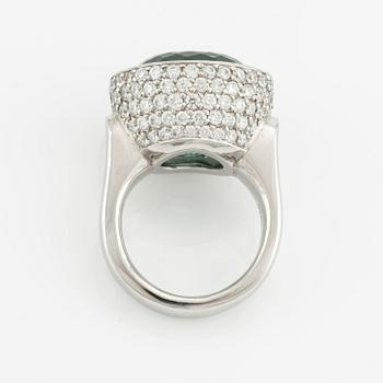 A Gaudy platinum ring with a faceted tourmaline and round brilliant-cut diamonds.