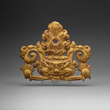 A Tibetan gilt metal ornament, 19th Century.