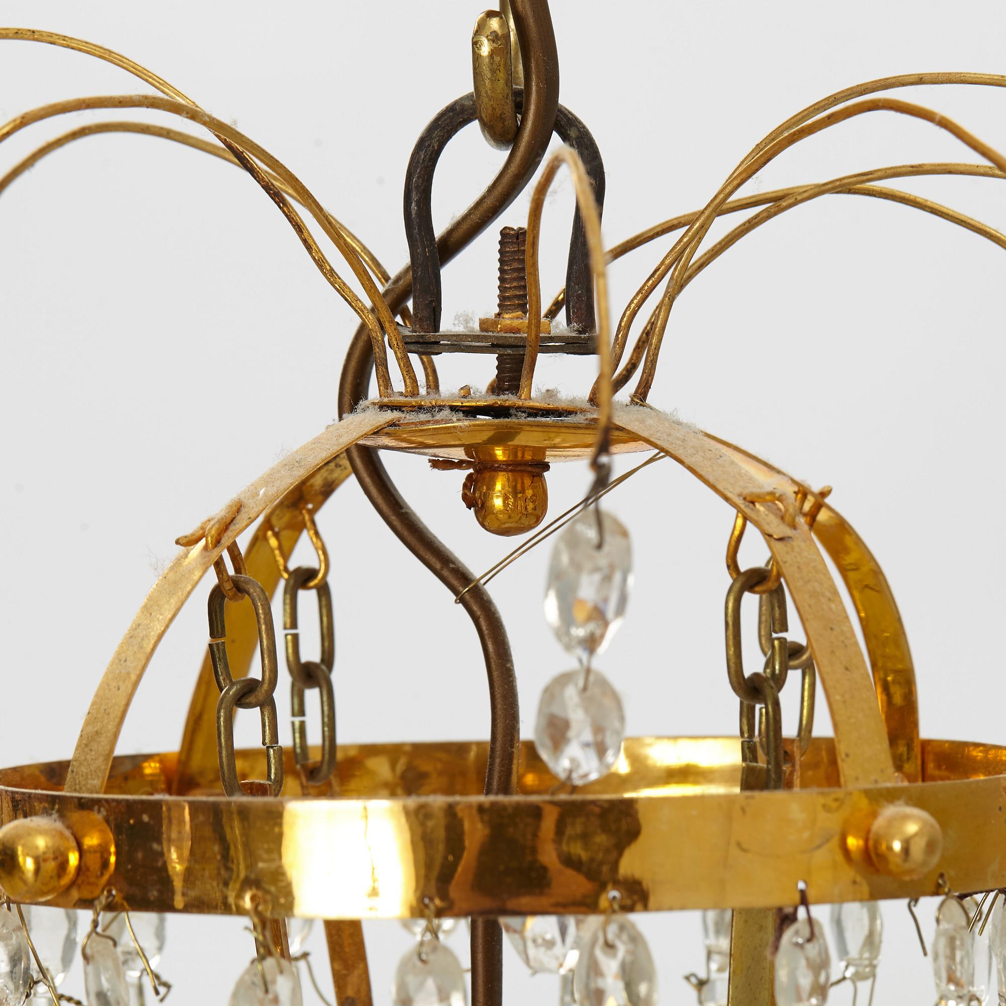 A late Gustavian gilt-brass and cut-glass four-branch chandelier, circa 1800.