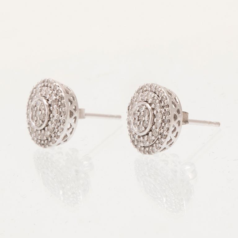 A pair of 14K white gold earrings set with round single-cut diamonds.