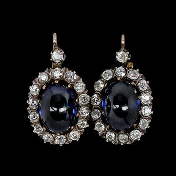 1003. EARRINGS, antique cut diamonds, tot. app. 2.50 cts, set with blue glass stones.