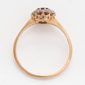 A 14K gold ring, with a pink sapphire and diamonds.