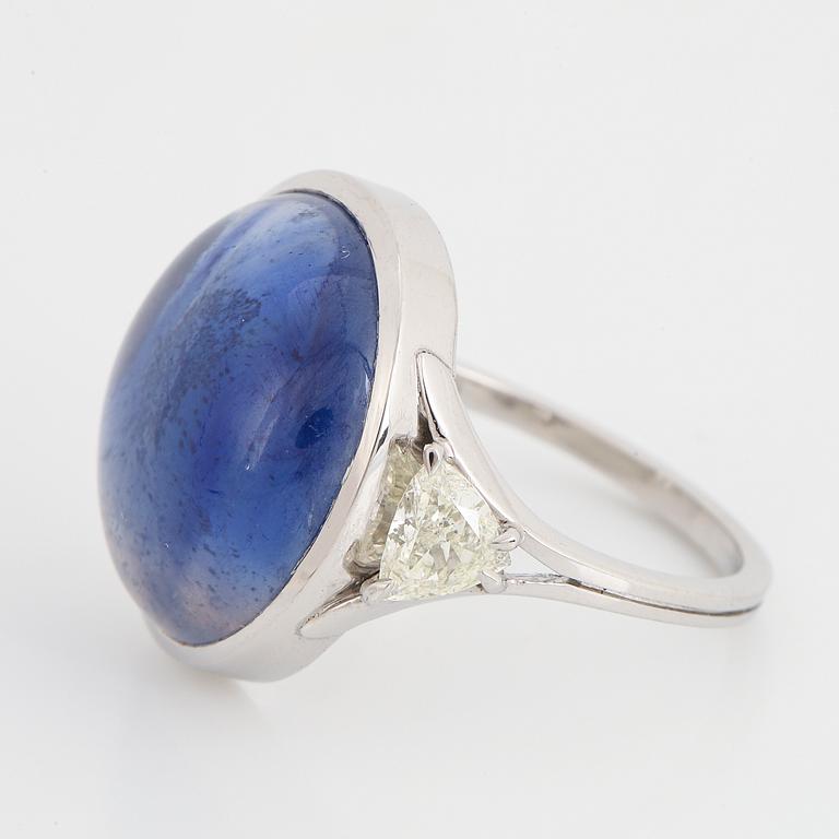 Cabochon-cut sapphire and triangle shaped diamond ring.