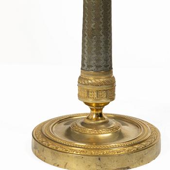 A pair of French Empire ormolu candlesticks, early 19th century.