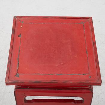 A pair of red Chinese small tables, 20th century.