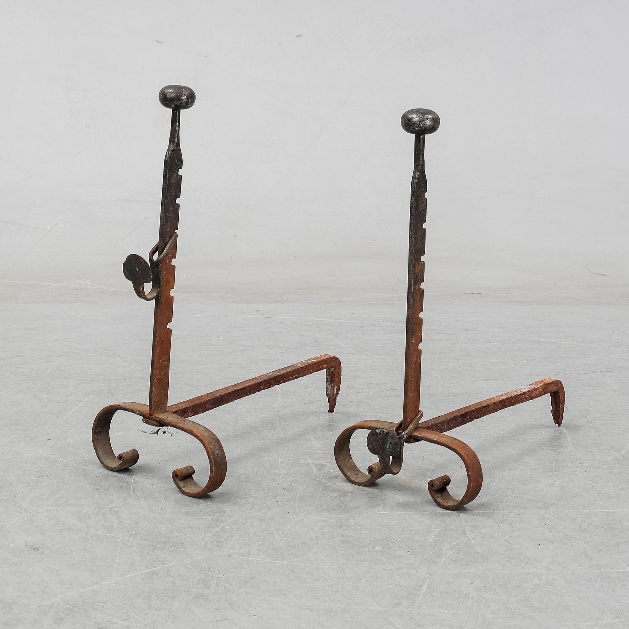 A pair of cast iron fire dogs, 20th Century.