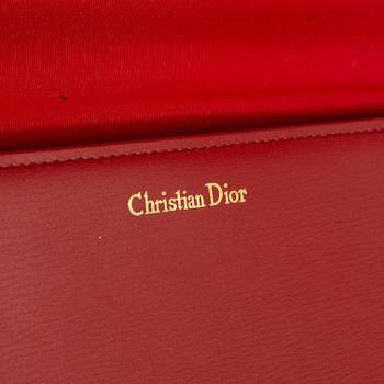 Christian Dior, a red box calf leather clutch.