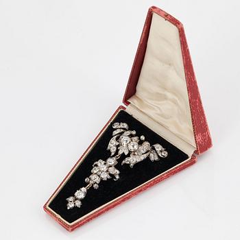 A 14K gold and silver brooch set with old-cut diamonds.