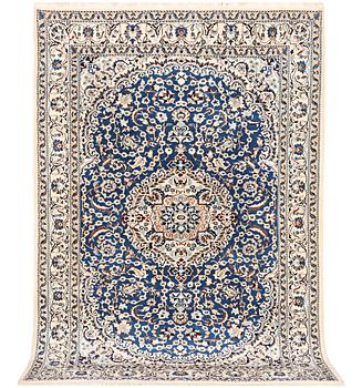 A Nain carpet, part silk, 9 laa, c. 300 x 189 cm.