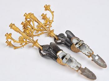 A pair of Napoleon III five-branch gilt and patinated bronze appliques.