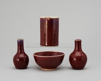 A set of one sang de boef-glazed bowl, a brush pot and two vases, Qing dynasty.