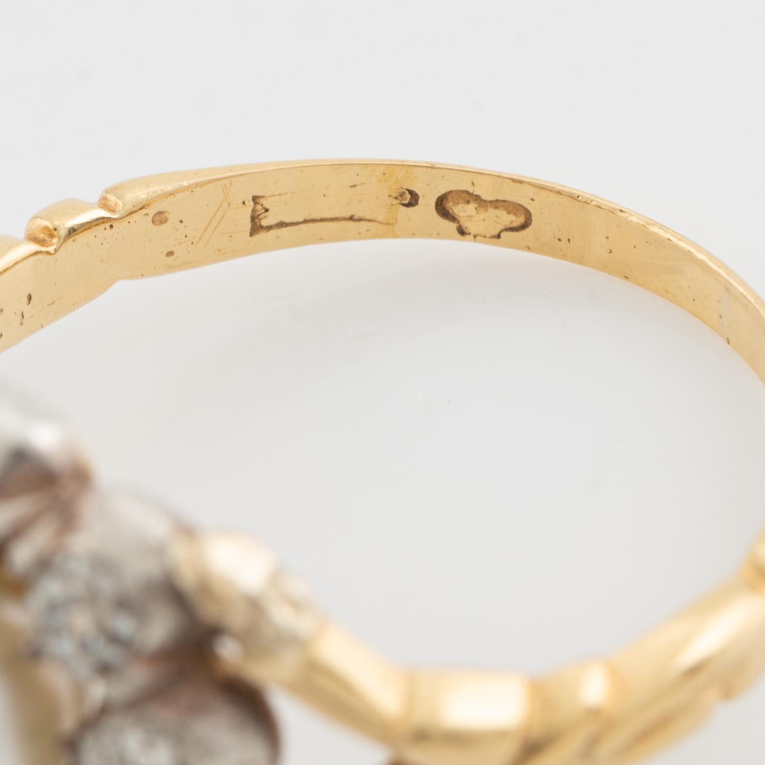 An 18K gold ring and silver set with a pearl and old-cut diamonds.