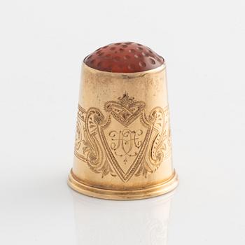 An 18K Gold Thimble with carnelian.