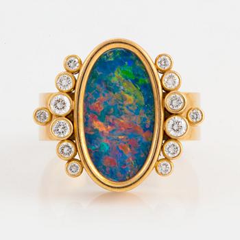 1040. An 18K gold and opal ring set with round brilliant-cut diamonds.