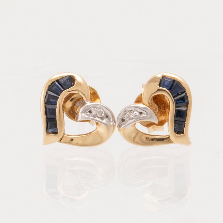 Bucherer a pair of 18K white and red gold earrings set with round brilliant-cut diamonds and blue stones.