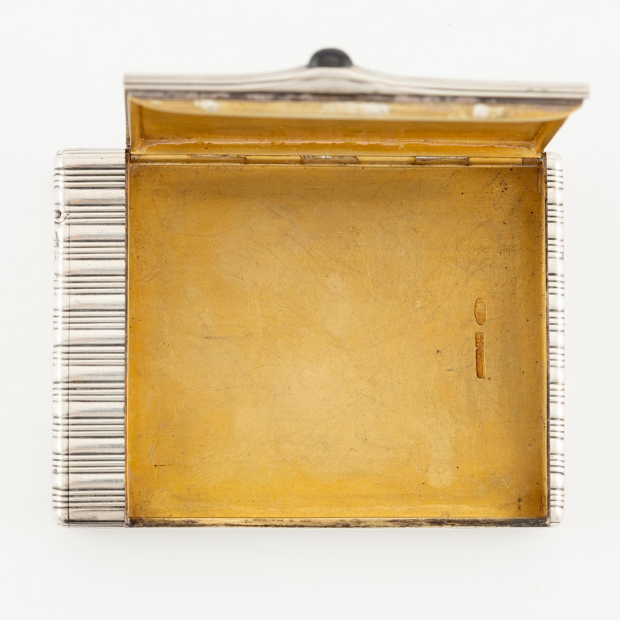 A Silver-gilt Fabergé Cigarette and Match Case, workmaster August Frederik Hollming, St. Petersburg 1908-1917.