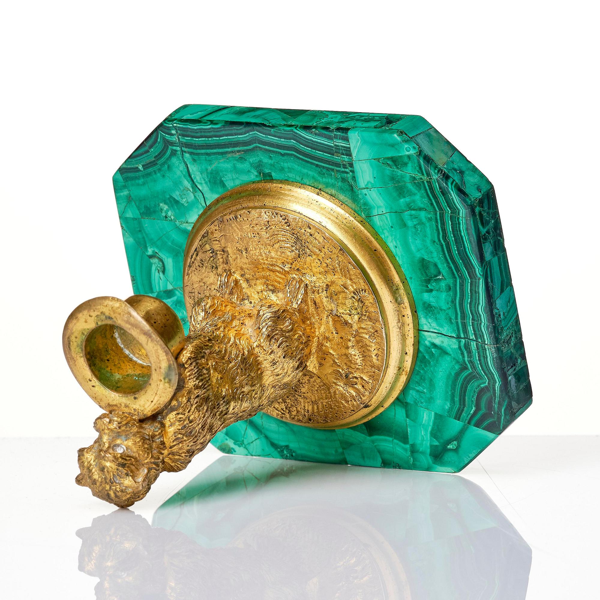 A Russian Nicholas II malachite-veneered and gilt-bronze candlestick, late 19th century.