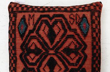 A carriage cushion, knotted pile in relief, ca 106 x 47, southwest of Scania, Sweden, circa 1800.