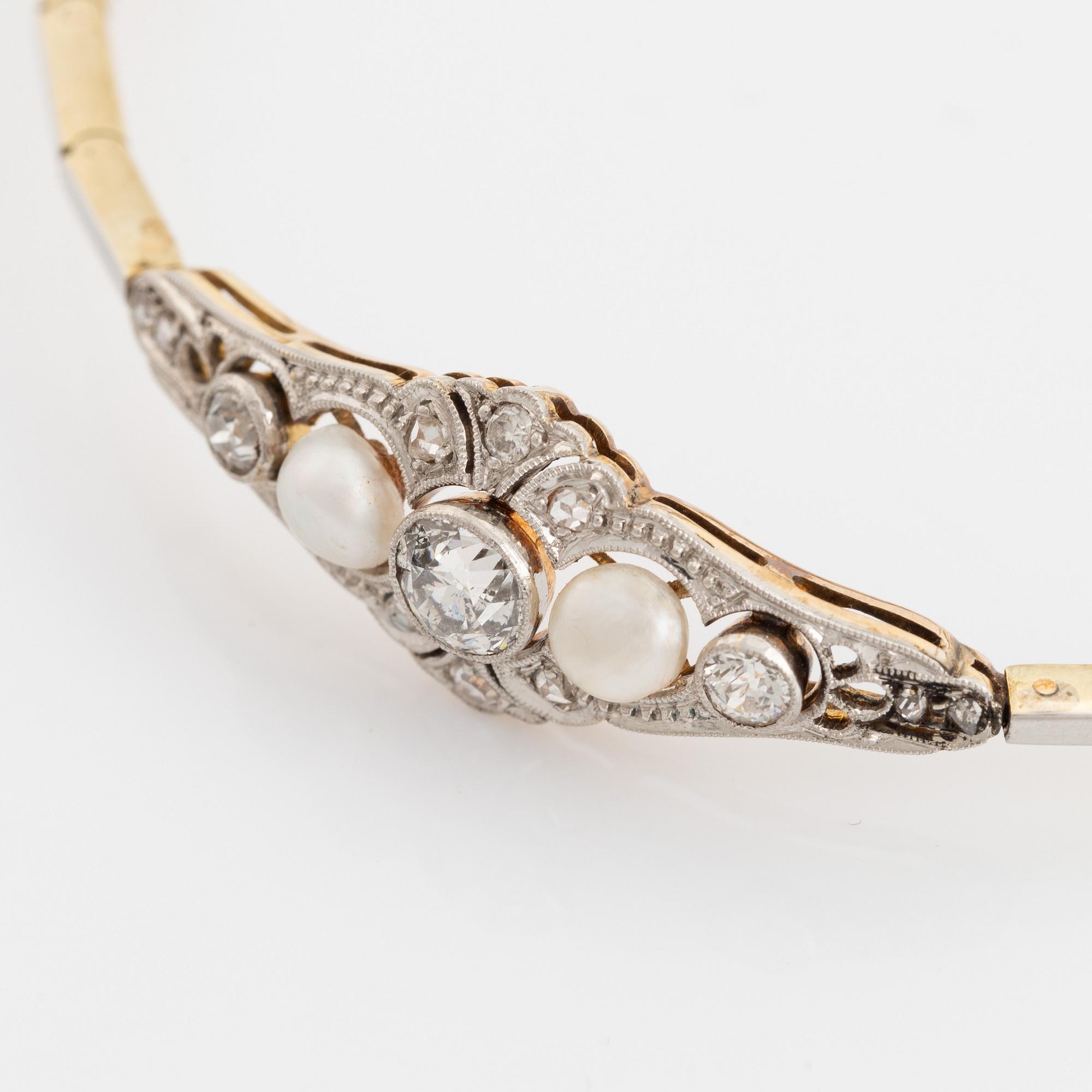 A 14K gold and platinum bracelet set with old- and rose-cut diamonds and pearls.