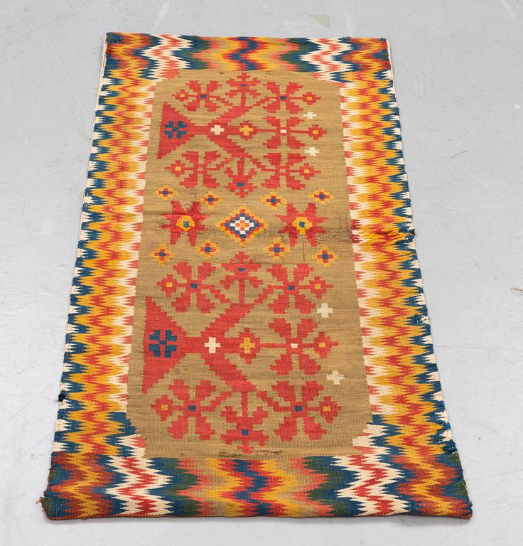 A carriage cushion, double-interlocked tapestry, ca 50 x 99,5 cm, Scania, (Sweden), first half of the 19th century.