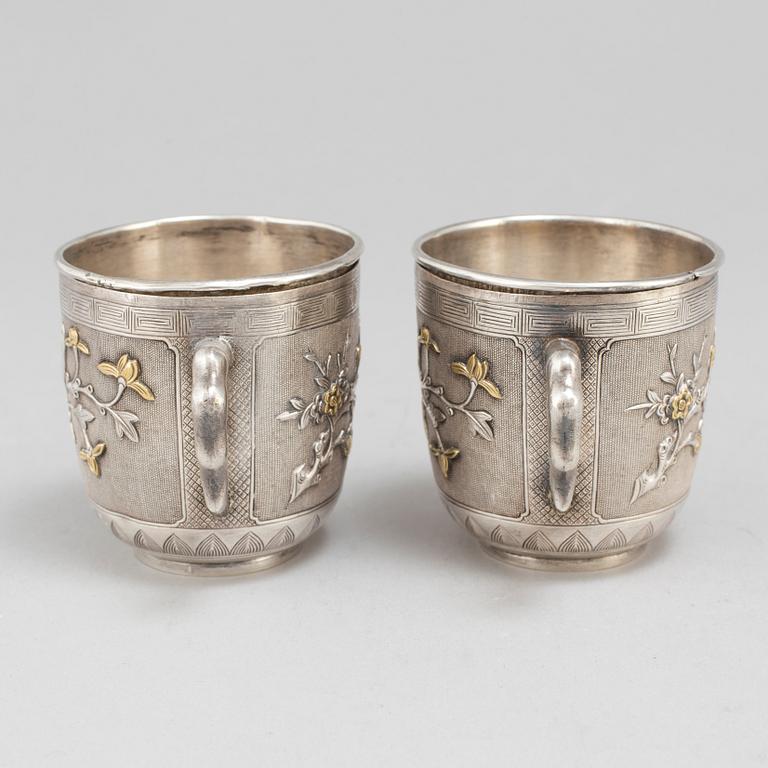 A pair of Chinese silver coffee cups with liners, early 20th Century.