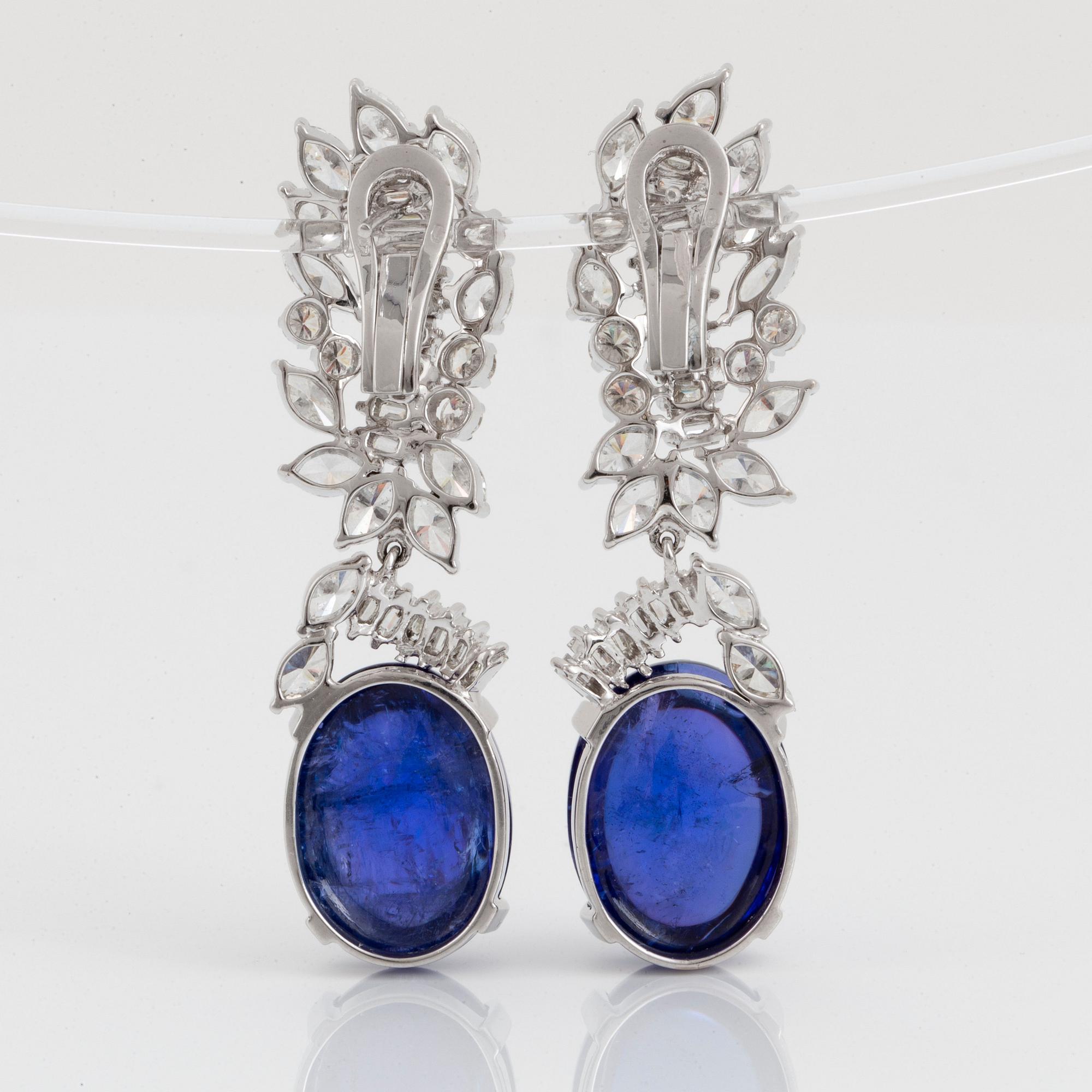 A pair of 18K gold tanzanite earings set with diamonds of various shapes.