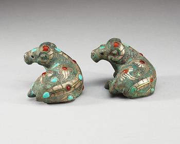 A pair of archaistic bronze figures of rams.
