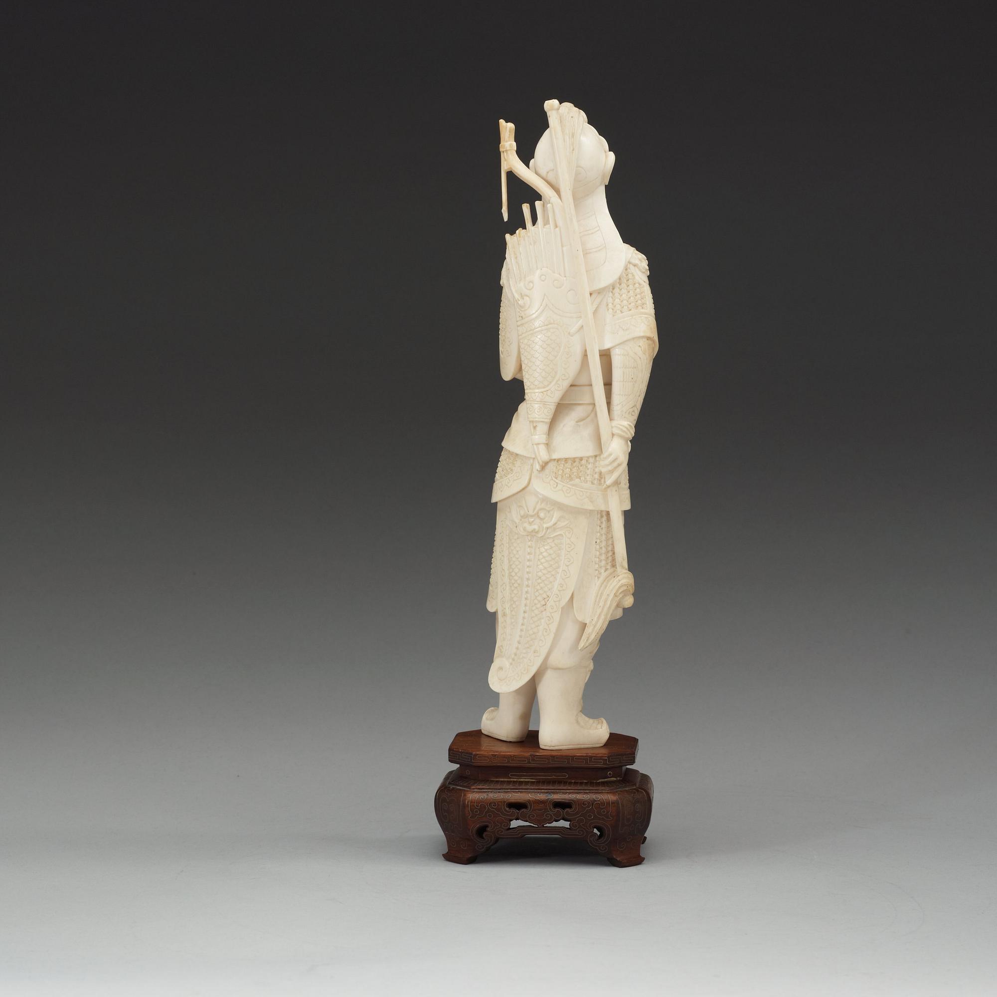 A carved ivory figure of a soldier in arms, late Qing dynasty, circa 1900.
