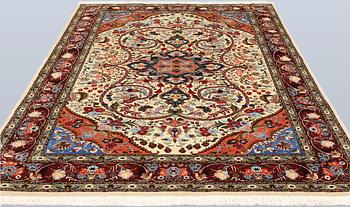 A part silk Tabriz rug, so-called 50 Raj, approx. 242 x 178 cm.