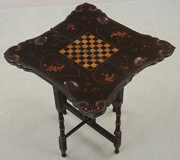 A black and gold laquered games table, 18-19th century.