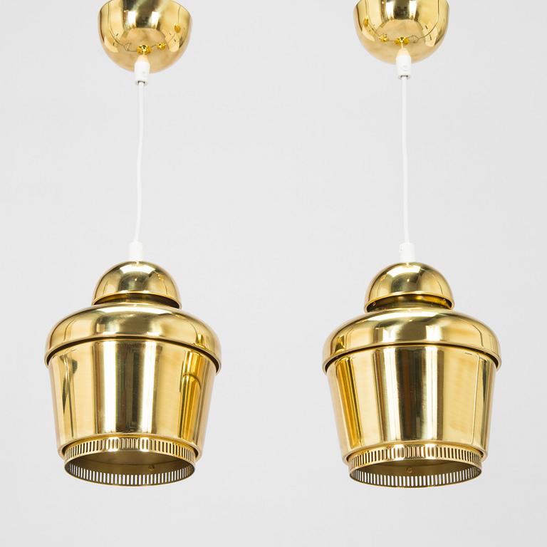 Alvar Aalto, A pair of  A 330, 'Golden Bell' pendant lights A330 for Artek, 2000s.