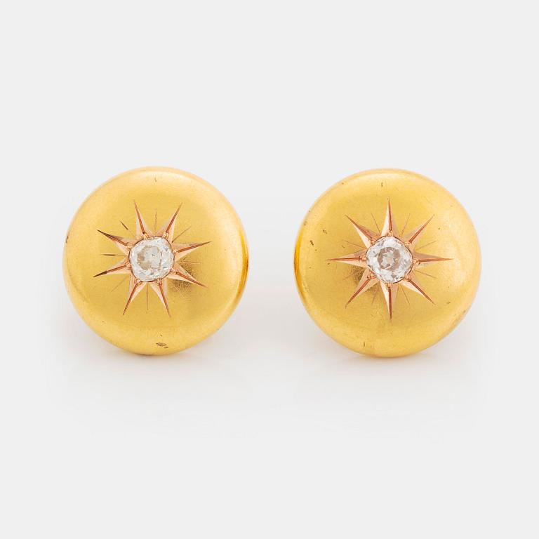 A pair of 18K gold cufflinks set with old-cut diamonds.