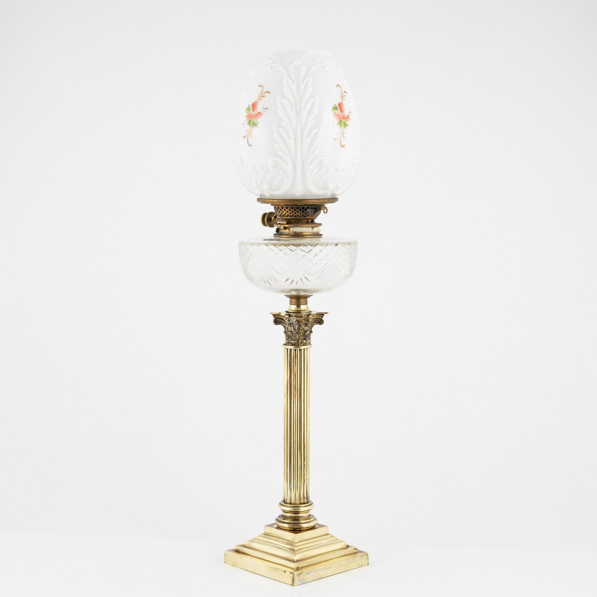 A brass and glass column shaped paraffin lamp, end of the 19th Century.