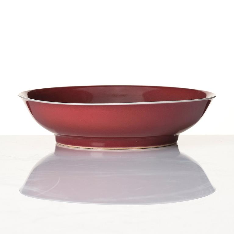 A 'copper-red' glazed dish, Qing dynasty with Kangxi six character mark and of the period (1662-1722).