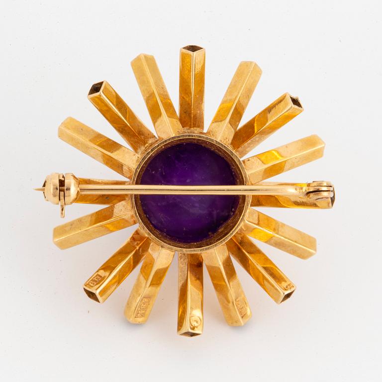 An 18K gold and cabochon-cut amethyst brooch by Engelbert.