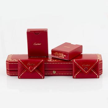 An 18K white gold Cartier "Spartacus" bracelet with two charms.